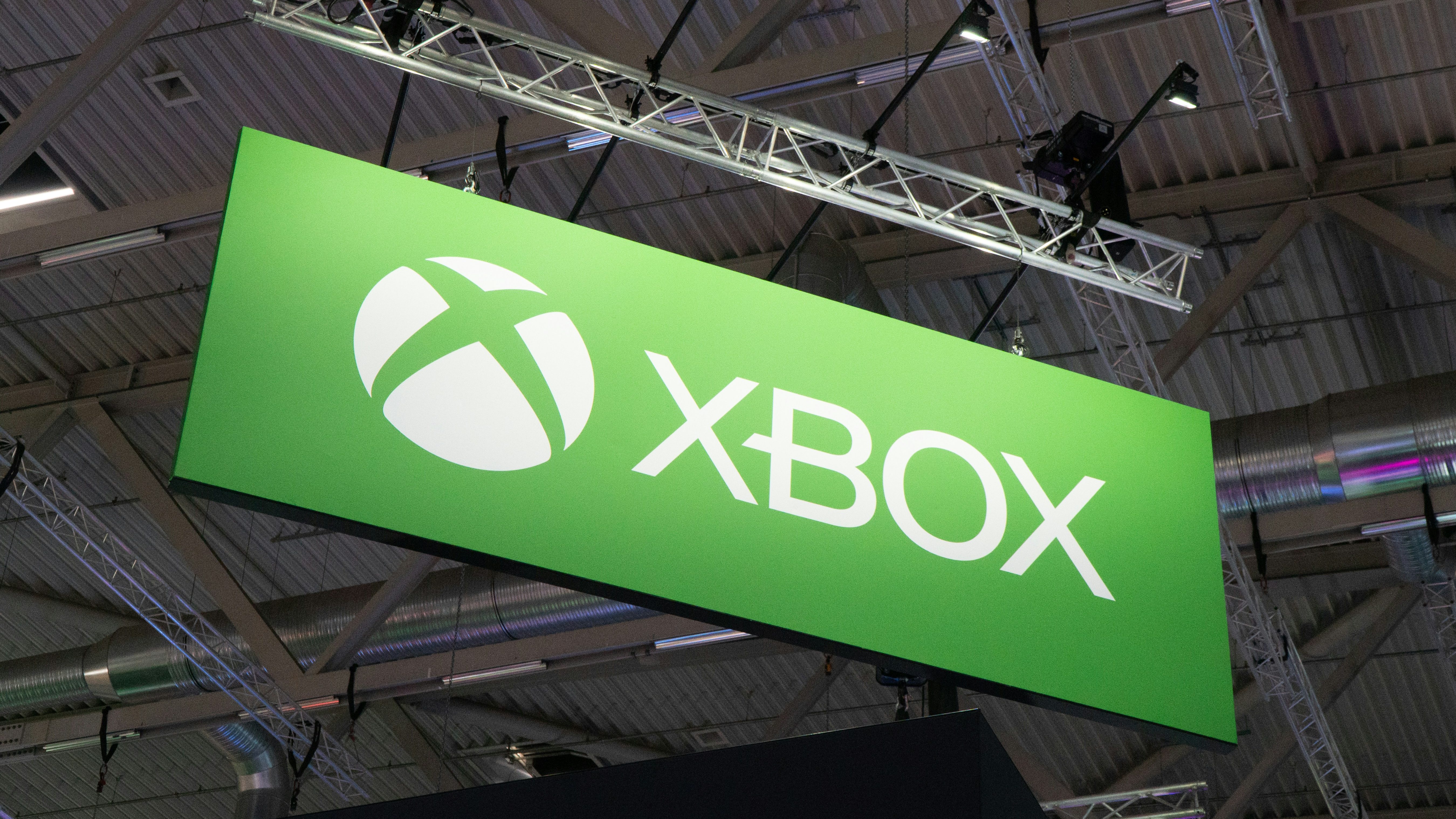 Picture of the Xbox logo on a board hanging from the rafters