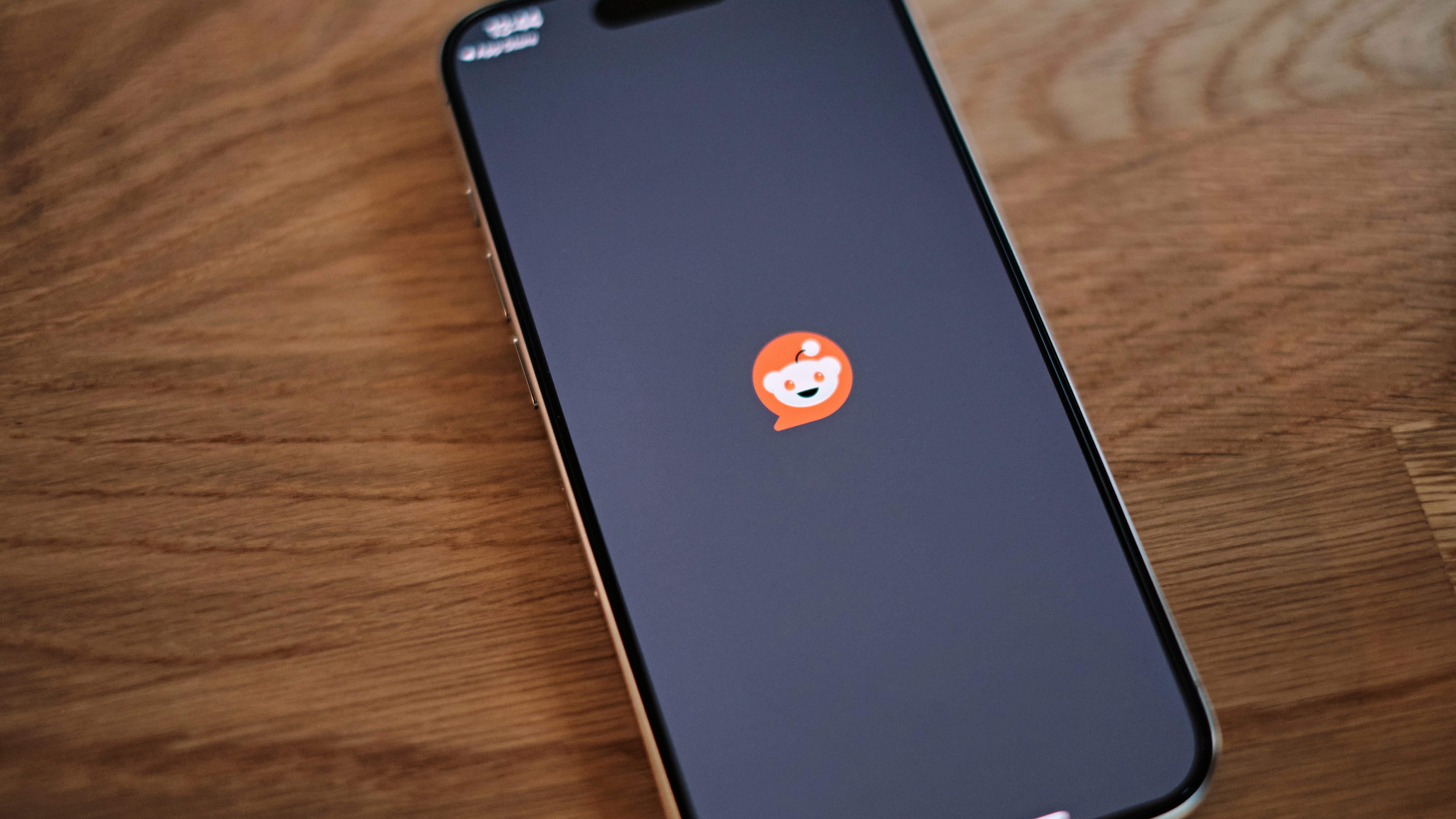 Image of the Reddit logo on an iPhone