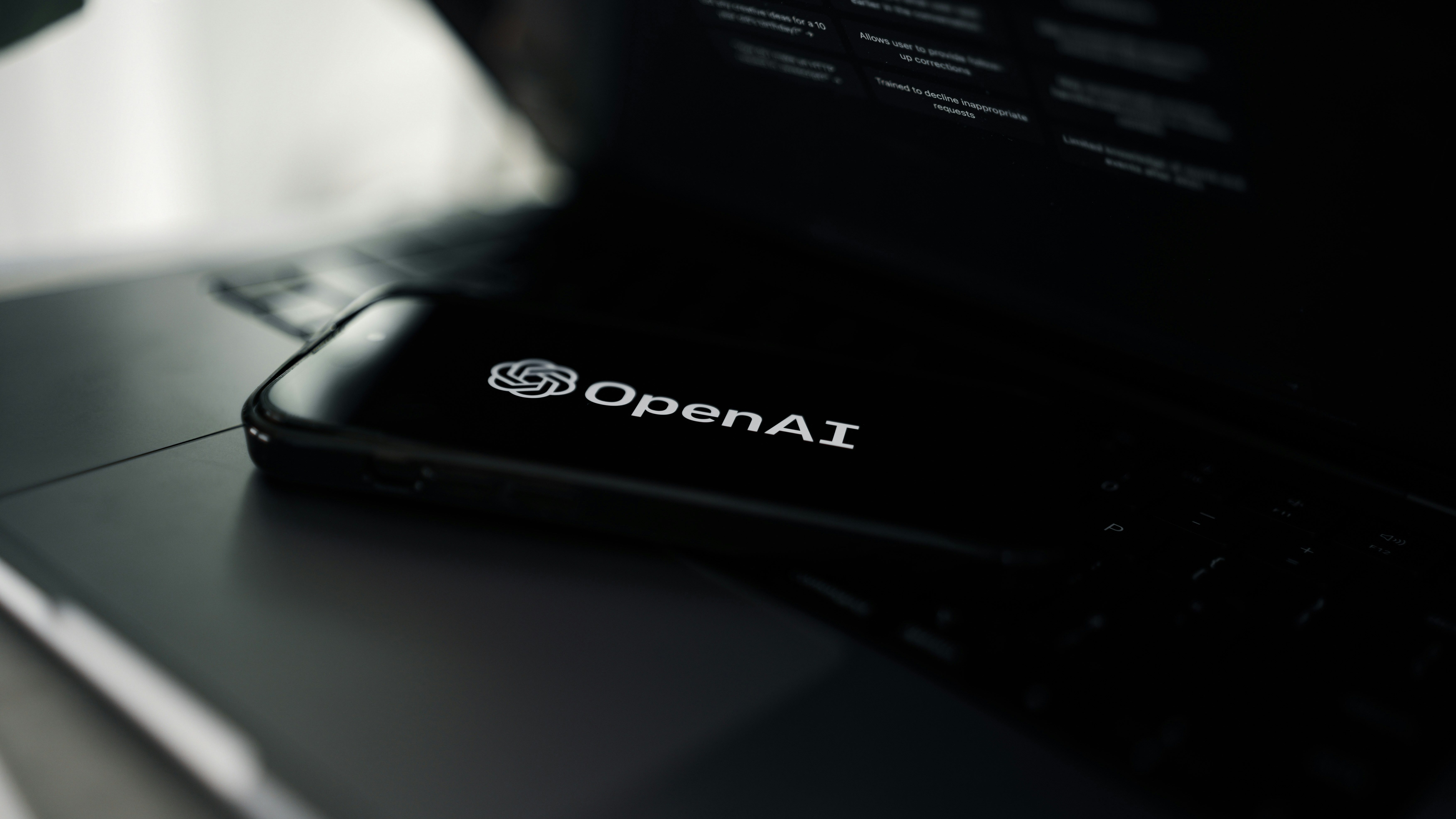 Photo of the OpenAI logo on a phone