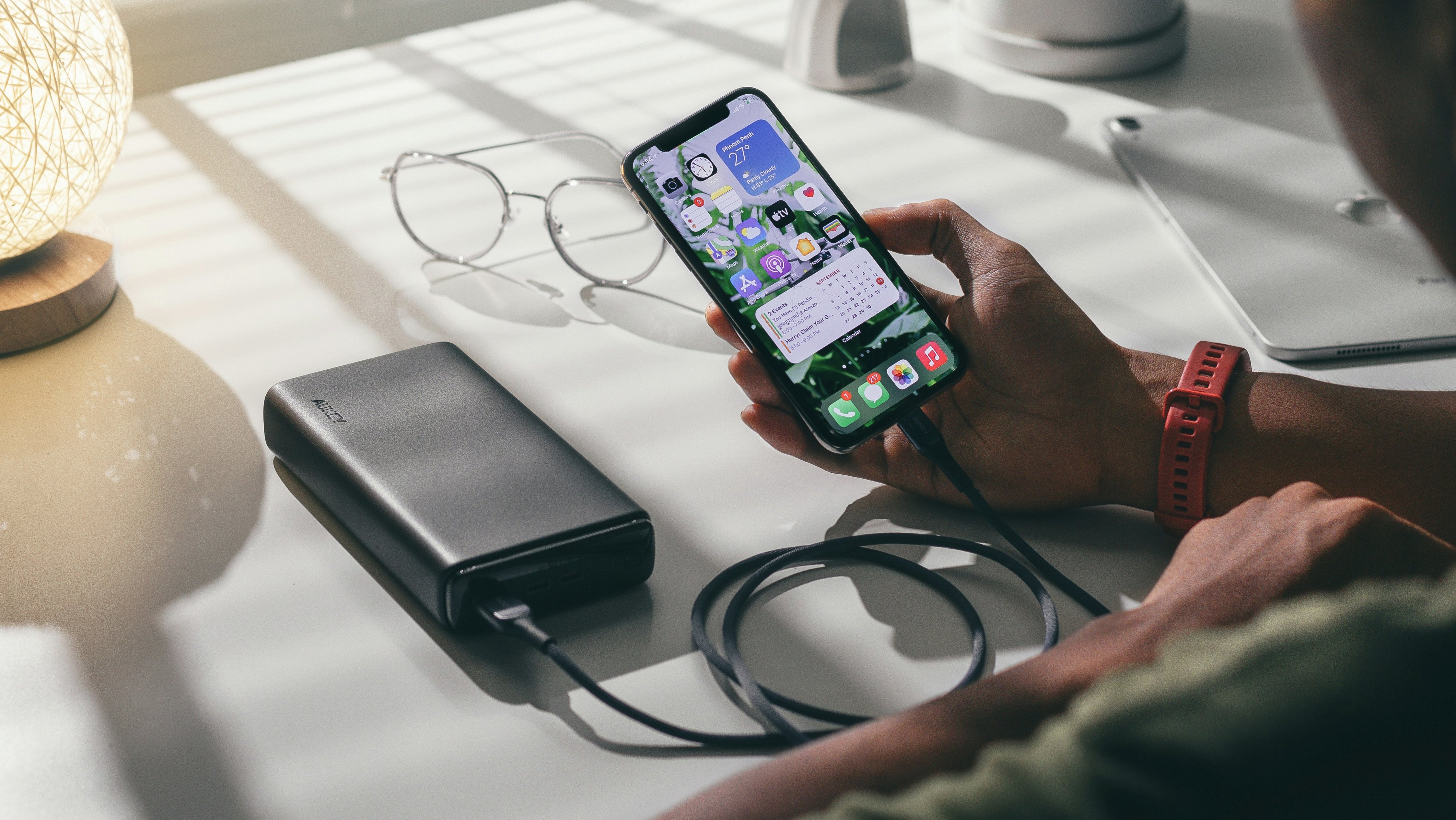 Person holding a phone while it's charging