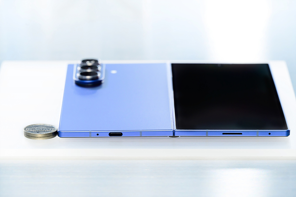 Press image showing two quarters next to an unfolded Samsung Galaxy Z Fold 7